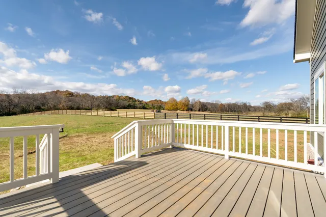 a view of a balcony with wooden floor space and outdoor space