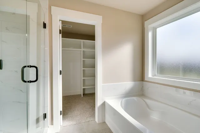 a bathroom with a tub shower and a sink