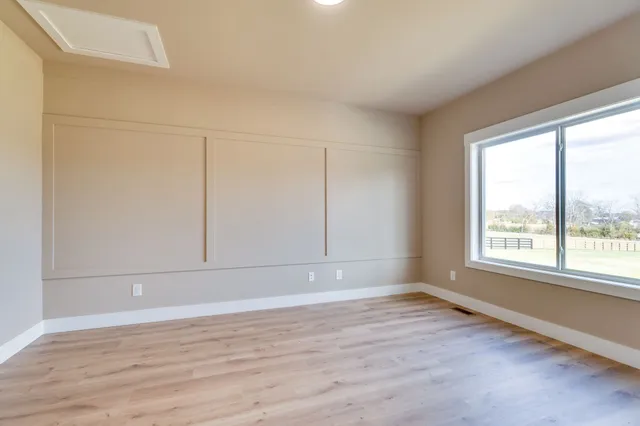 wooden floor in an empty room with a window
