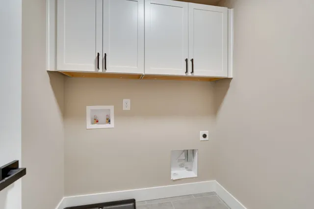 a view of kitchen with white cabinets