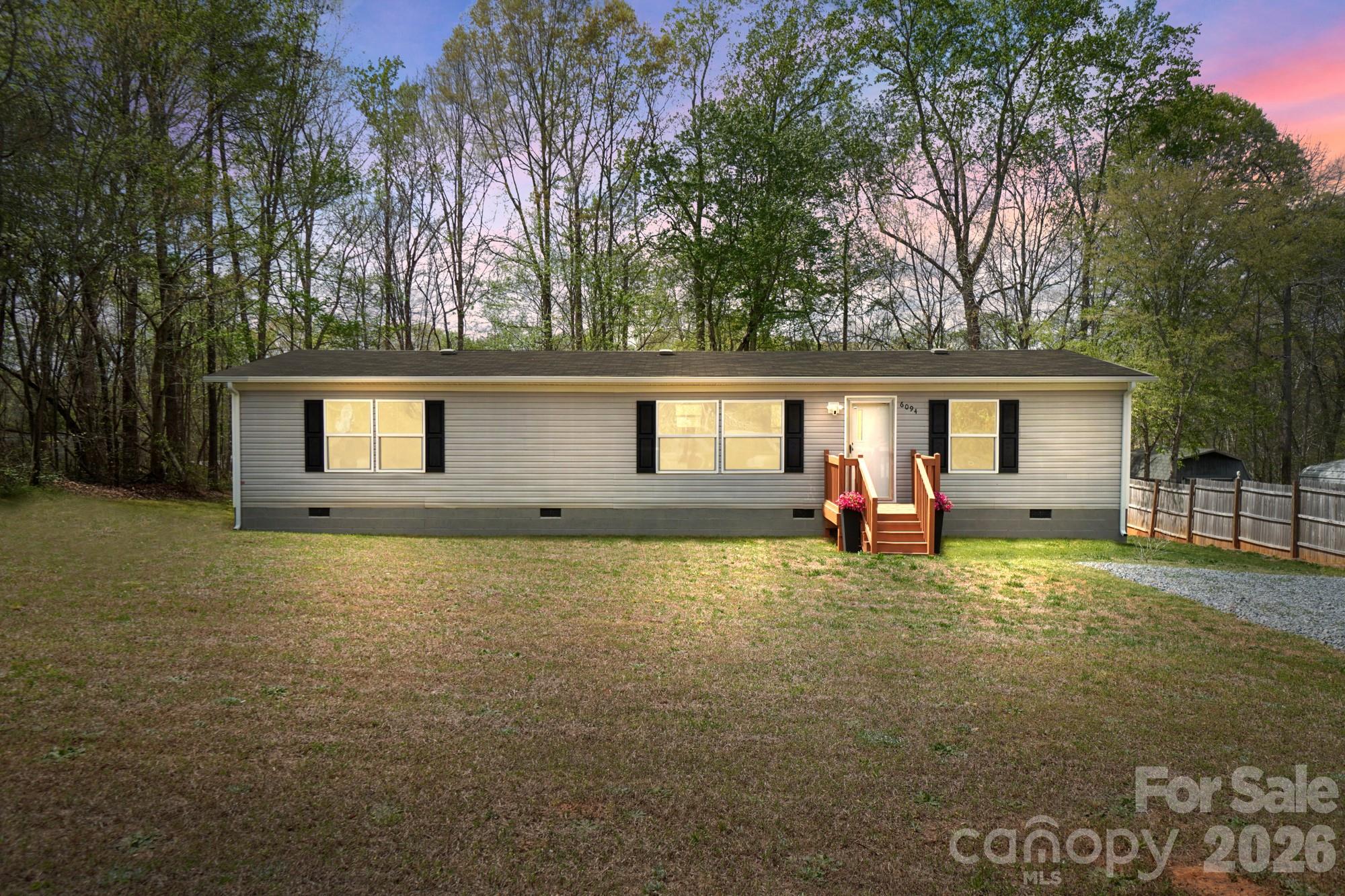 a view of a house with a backyard