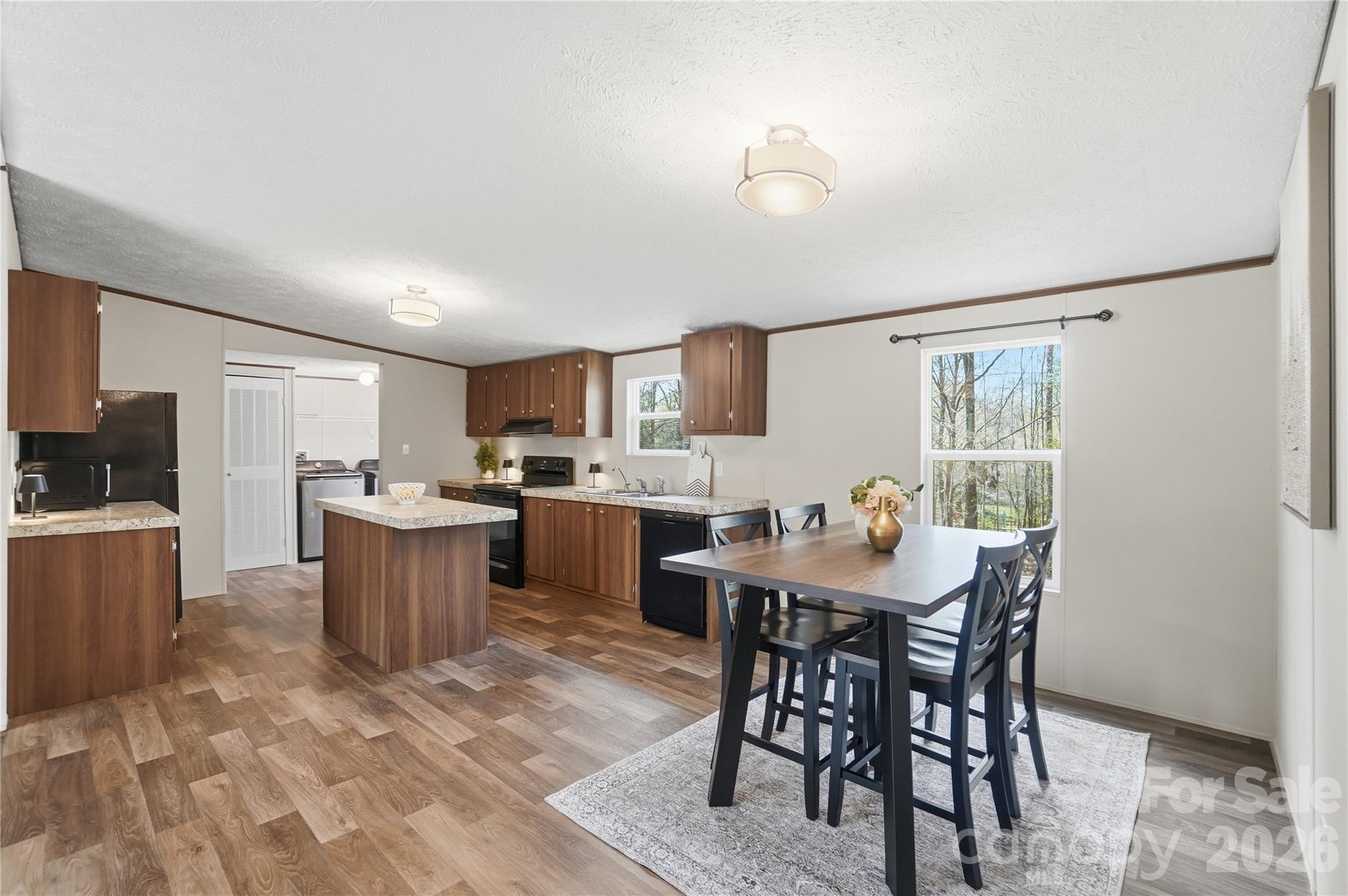 6094 Burnhurst Lane Denver, NC 28037 - Photo 11 of 42 a view of a dining room with furniture and a kitchen
