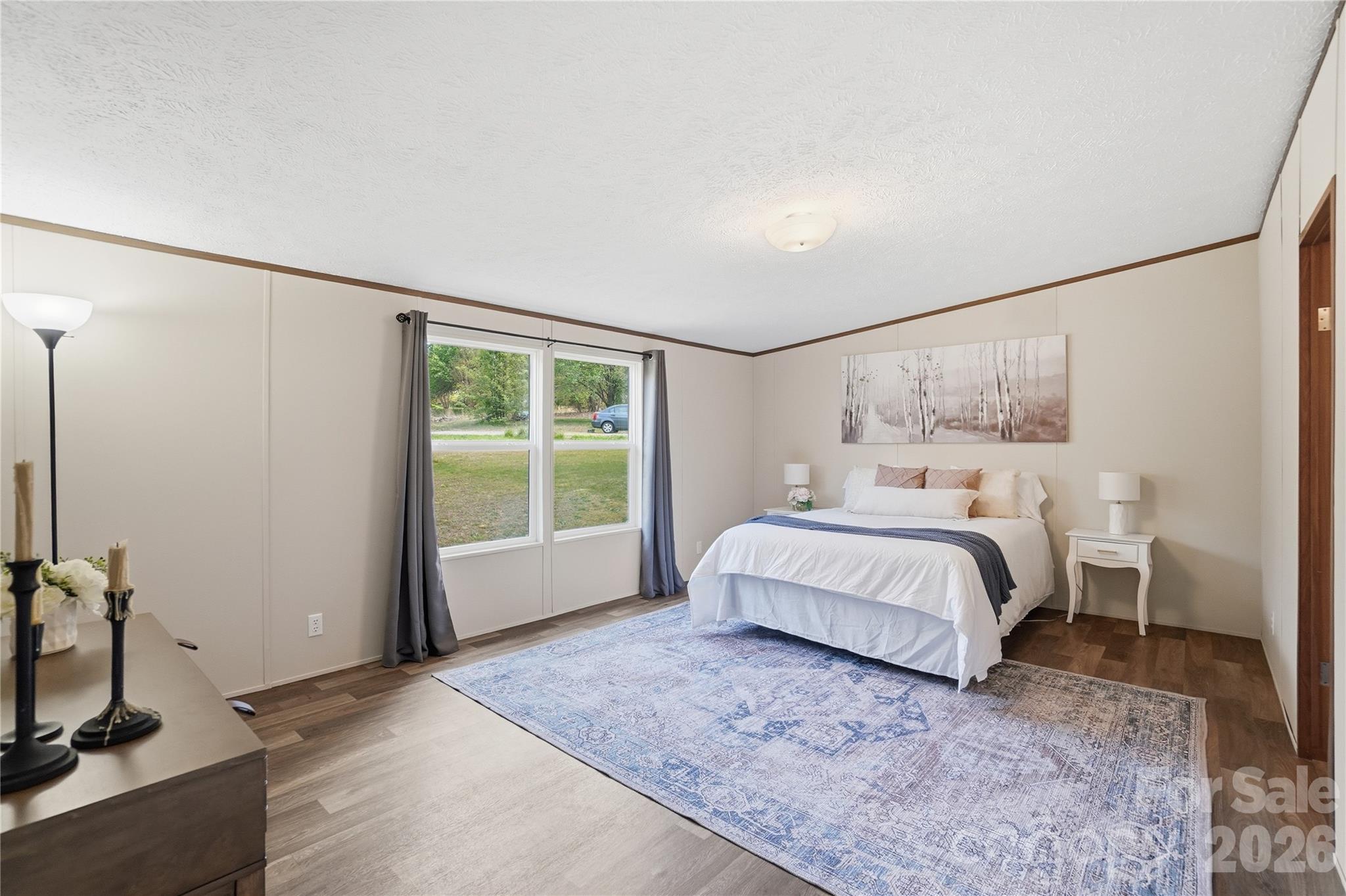 6094 Burnhurst Lane Denver, NC 28037 - Photo 19 of 42 a spacious bedroom with a bed and a window