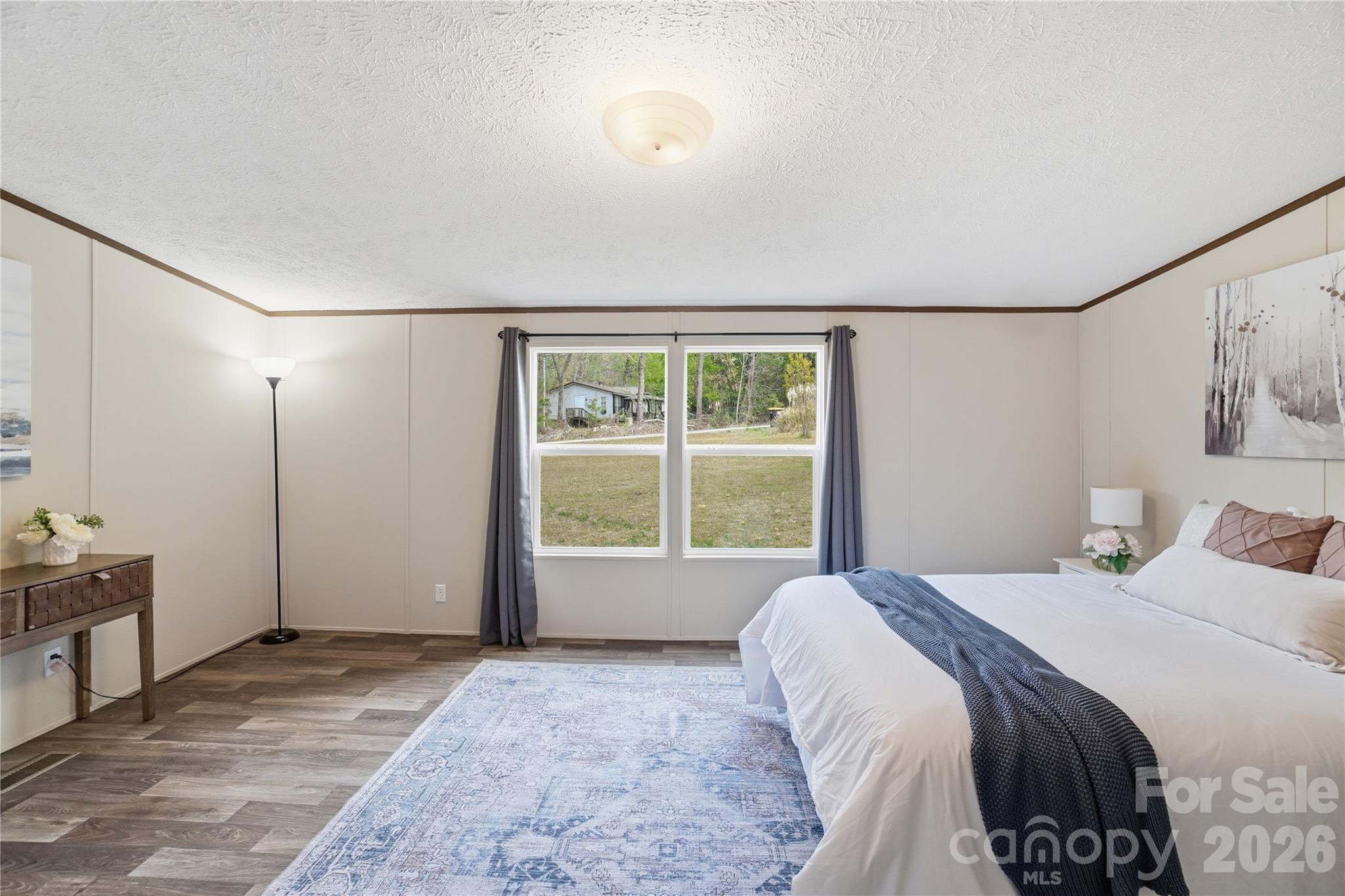 6094 Burnhurst Lane Denver, NC 28037 - Photo 22 of 42 a spacious bedroom with a large bed and a window