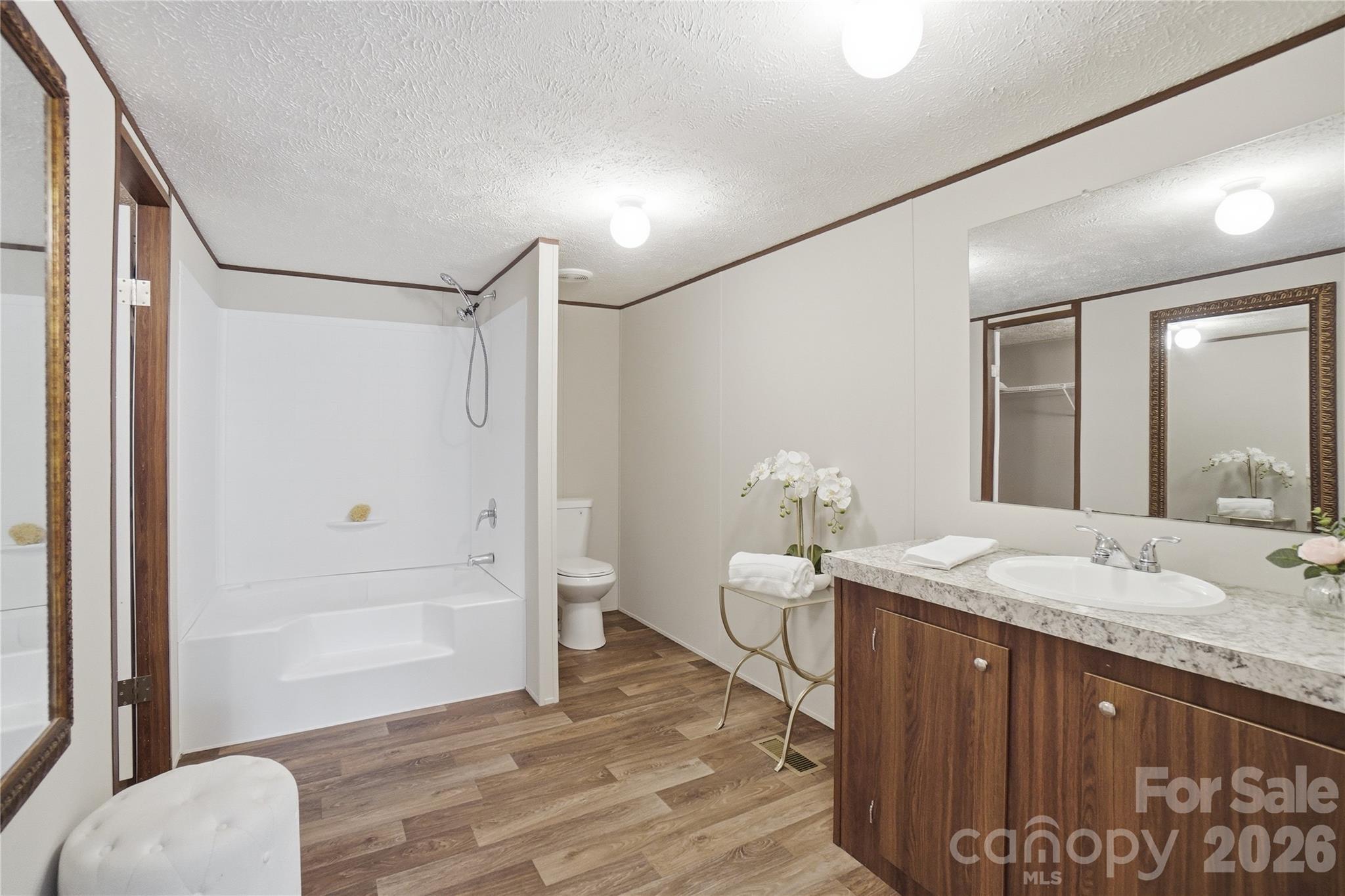 6094 Burnhurst Lane Denver, NC 28037 - Photo 23 of 42 a spacious bathroom with a granite countertop sink and a mirror
