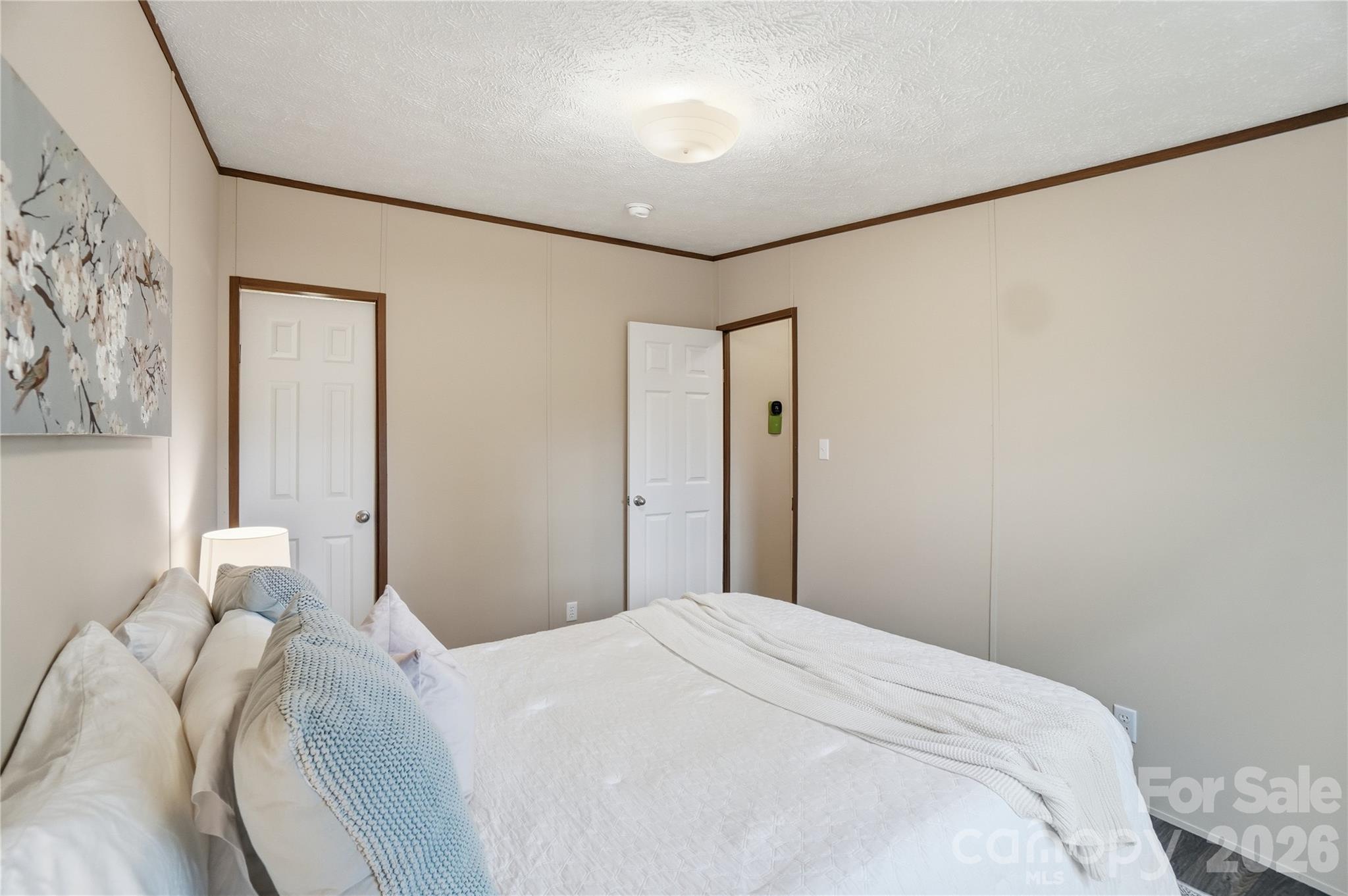 6094 Burnhurst Lane Denver, NC 28037 - Photo 28 of 42 a bedroom with a bed and a painting on the wall