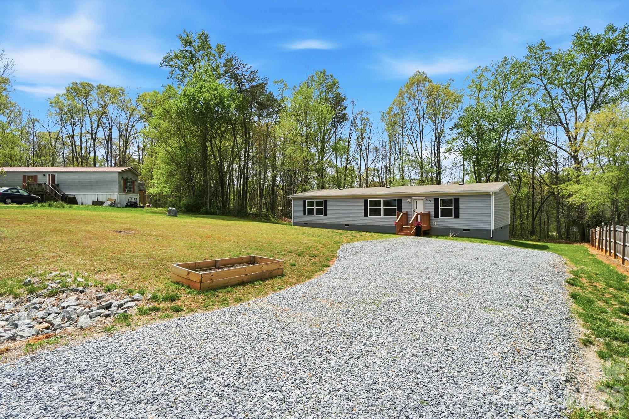 6094 Burnhurst Lane Denver, NC 28037 - Photo 41 of 42 a front view of a house with a yard and trees