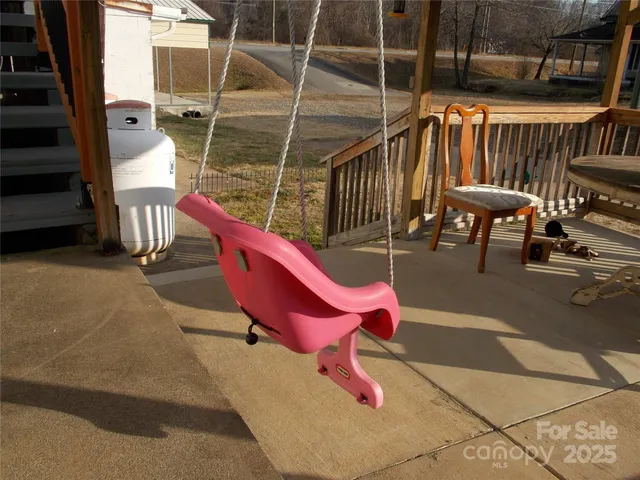 a sitting area with furniture and wooden fence