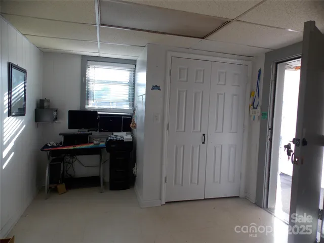 a living room with furniture a flat screen tv and a window