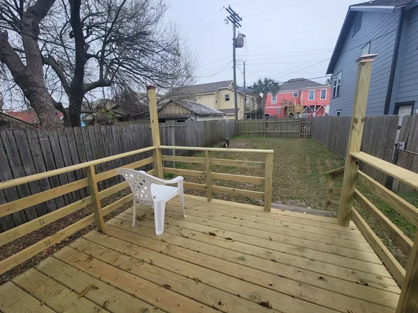 a backyard of a house with barbeque oven and outdoor seating