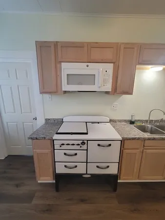 a bathroom with a toilet a sink and shower