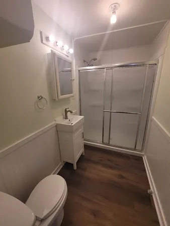 a view of an empty room with wooden floor