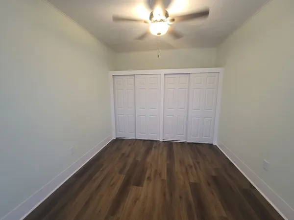 a view of walk in closet with empty racks
