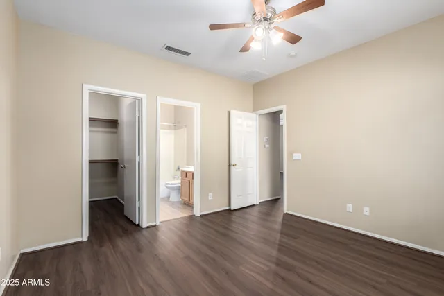 an empty room with wooden floor and closet