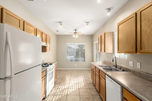 a large kitchen with a large window and refrigerator