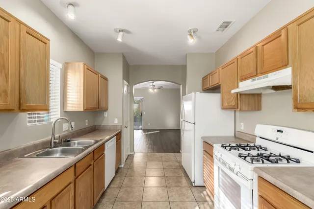 a kitchen with a sink stove and refrigerator