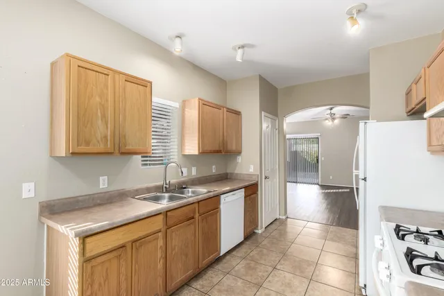 a kitchen with a sink cabinets and stainless steel appliances