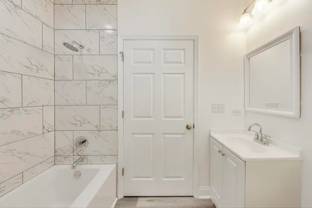 a bathroom with a bathtub and a sink