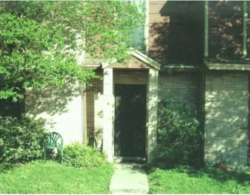 a backyard of a house with lots of green space and fountain