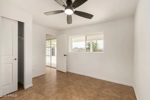 a view of empty room with ceiling fan
