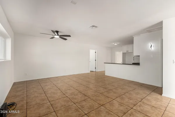 a view of a kitchen with a sink and a refrigerator