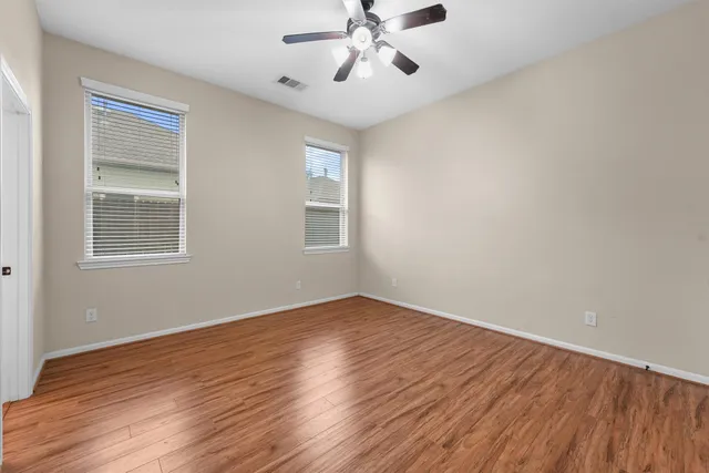 a view of an empty room with wooden floor
