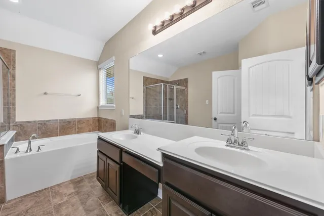a bathroom with a bathtub and a shower