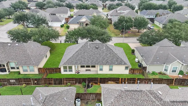an aerial view of residential houses with city view