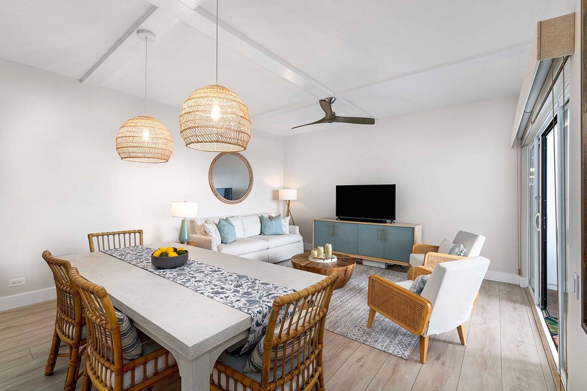75-6040 Alii Drive, Unit 704 Kailua-Kona, HI 96740 - Photo 11 of 30 a view of a dining room with furniture and wooden floor