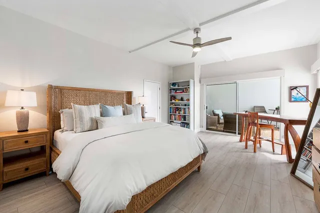 a bedroom with bed and wooden floor