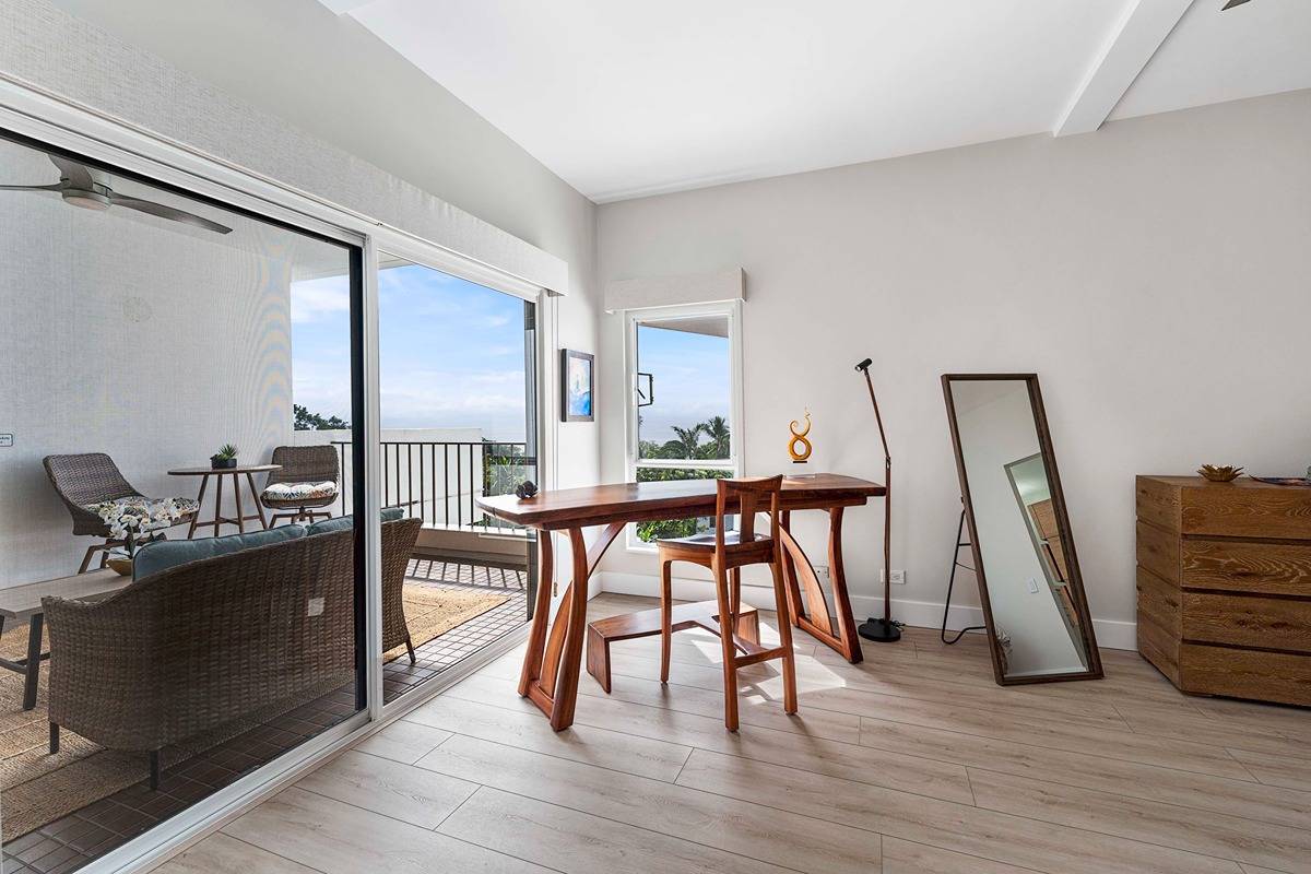 75-6040 Alii Drive, Unit 704 Kailua-Kona, HI 96740 - Photo 20 of 30 a workspace with furniture and wooden floor