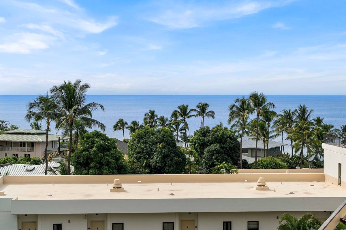 75-6040 Alii Drive, Unit 704 Kailua-Kona, HI 96740 - Photo 2 of 30 a potted plants sitting next to a white house