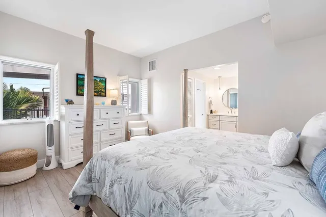 a large white bed in a white room