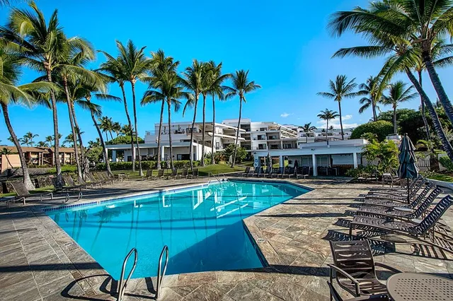a view of a swimming pool with lounge chairs