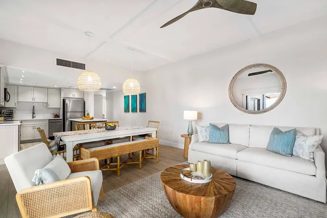 a living room with furniture kitchen and a mirror