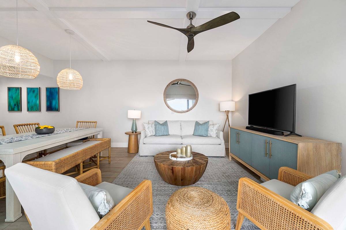 75-6040 Alii Drive, Unit 704 Kailua-Kona, HI 96740 - Photo 8 of 30 a living room with furniture and a flat screen tv