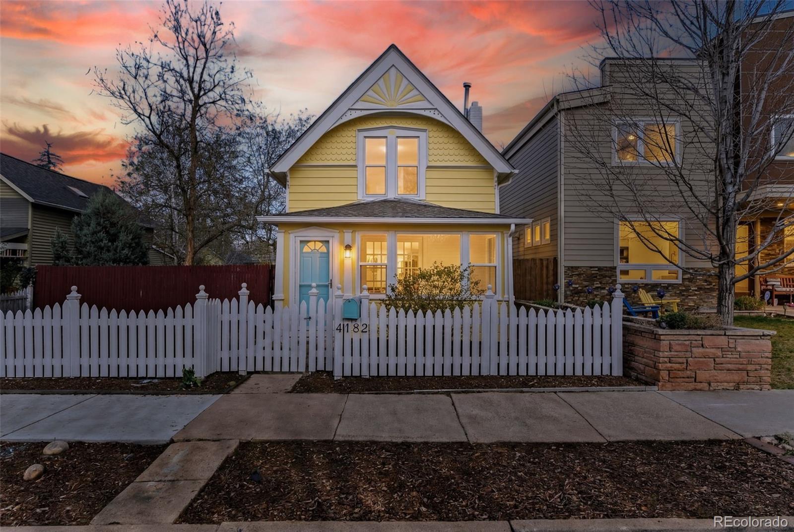 a view of a brick house with iron fence