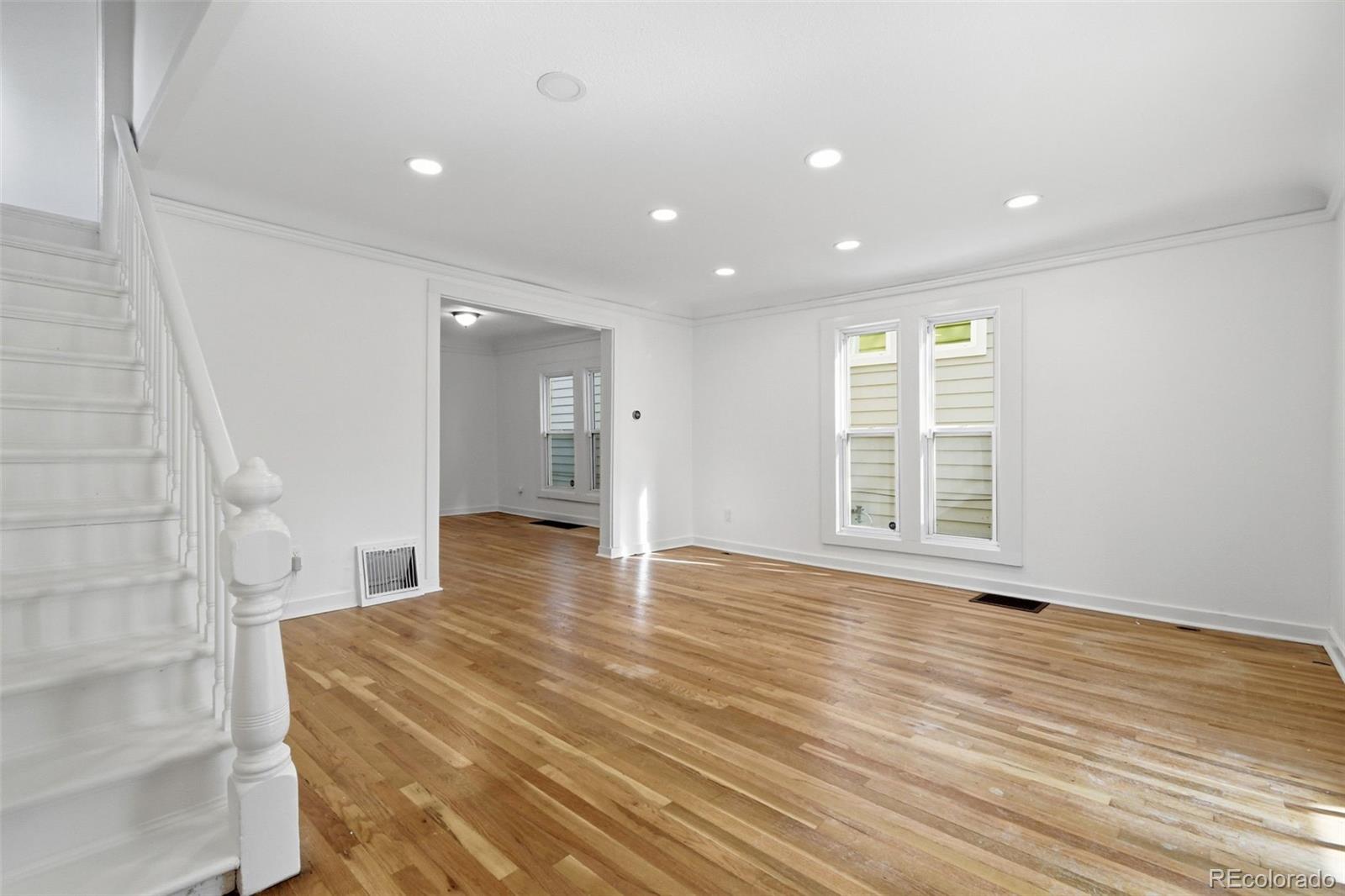 4182 Yates Street Denver, CO 80212 - Photo 11 of 48 a view of an empty room with wooden floor and a window