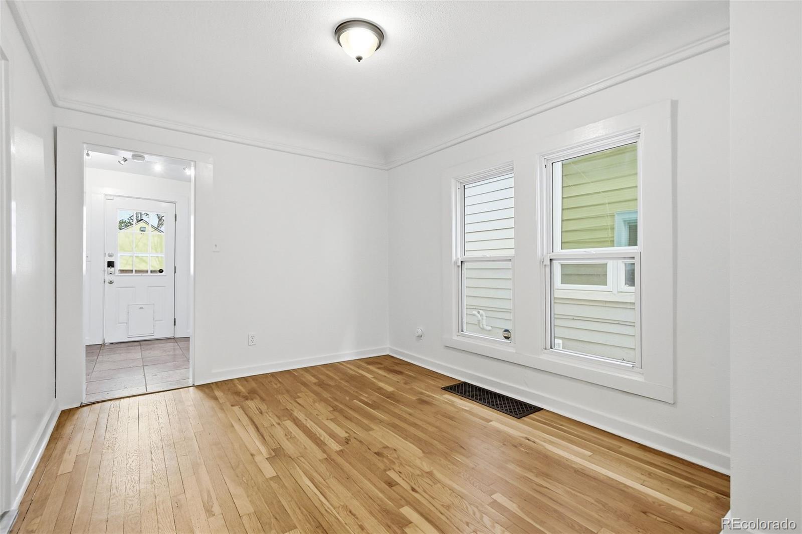 4182 Yates Street Denver, CO 80212 - Photo 13 of 48 a view of empty room with wooden floor and fan