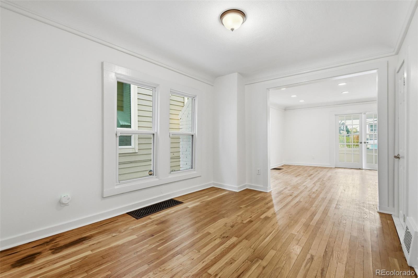 4182 Yates Street Denver, CO 80212 - Photo 15 of 48 an empty room with wooden floor and windows