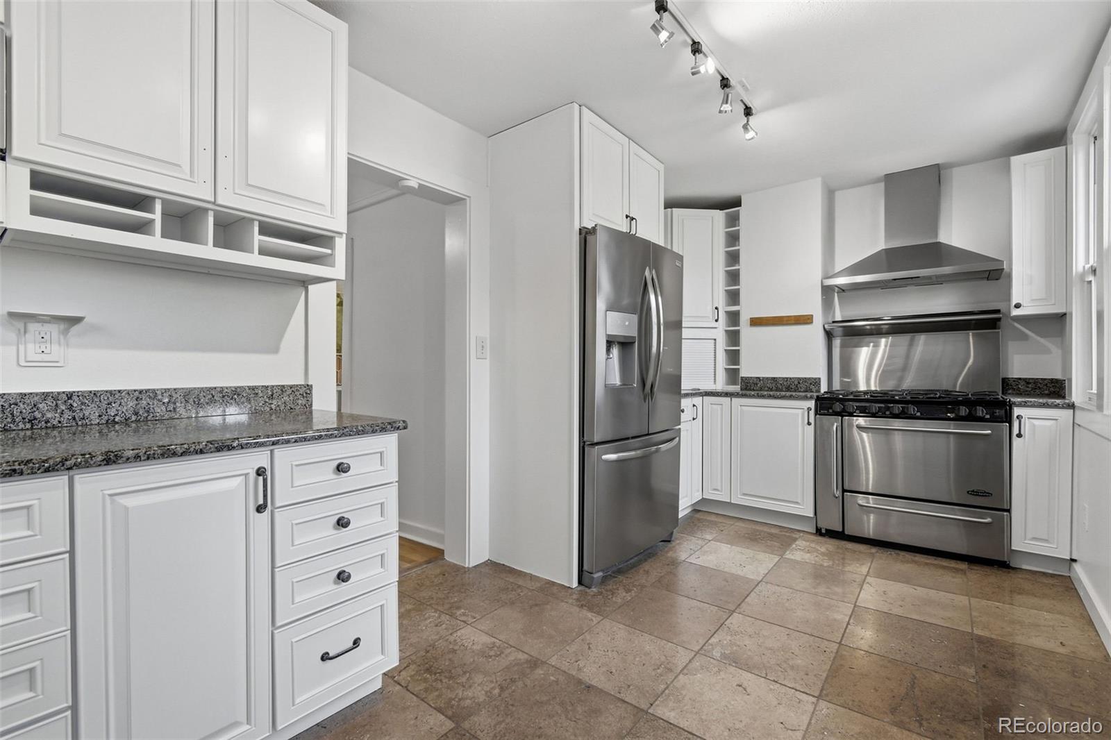4182 Yates Street Denver, CO 80212 - Photo 18 of 48 a kitchen with cabinets stainless steel appliances and a counter space