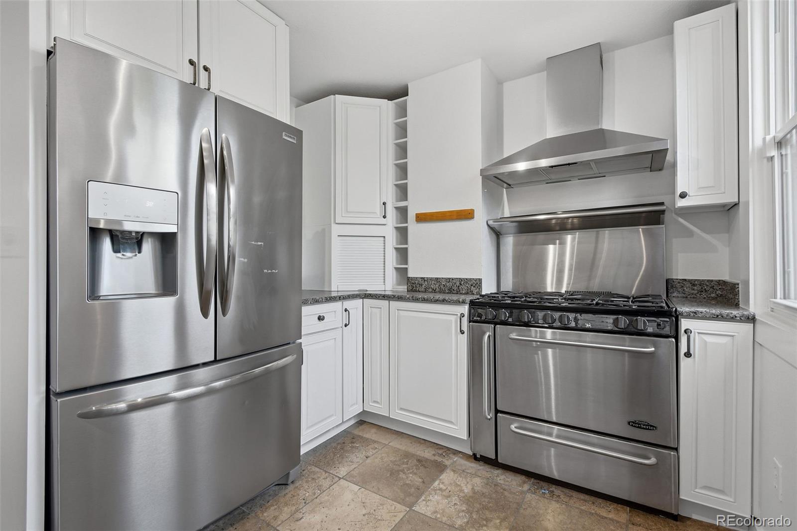 4182 Yates Street Denver, CO 80212 - Photo 19 of 48 a stove top oven sitting inside of a kitchen