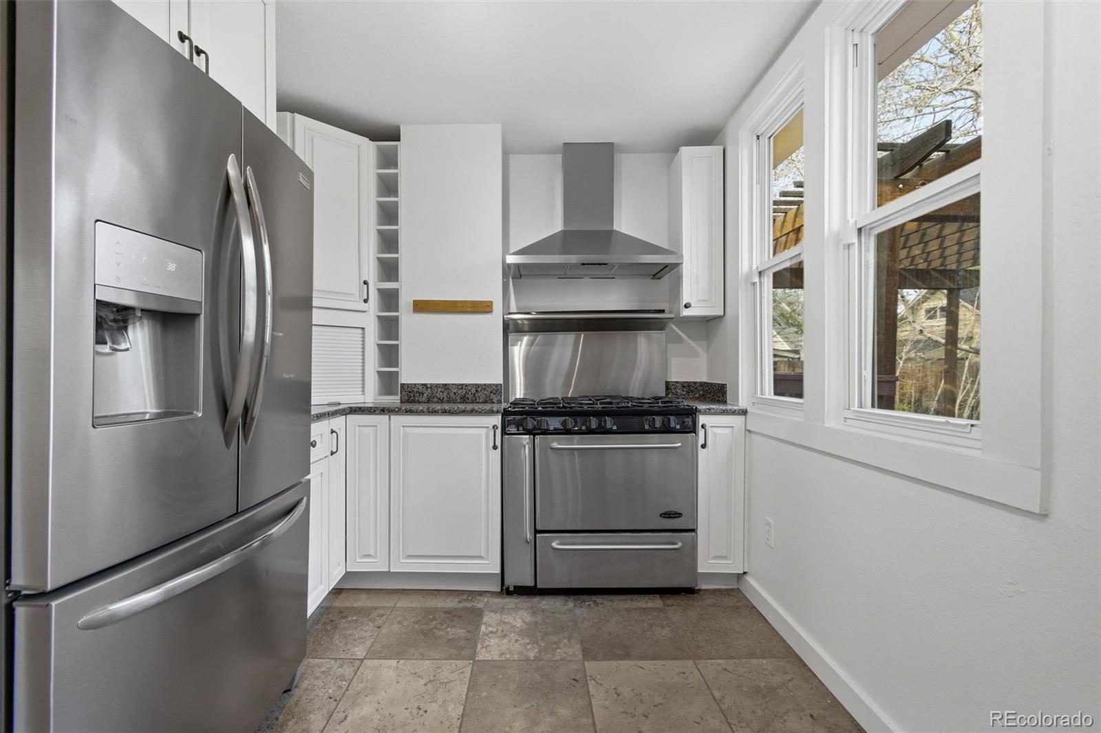 4182 Yates Street Denver, CO 80212 - Photo 20 of 48 a kitchen with stainless steel appliances granite countertop a refrigerator and a stove