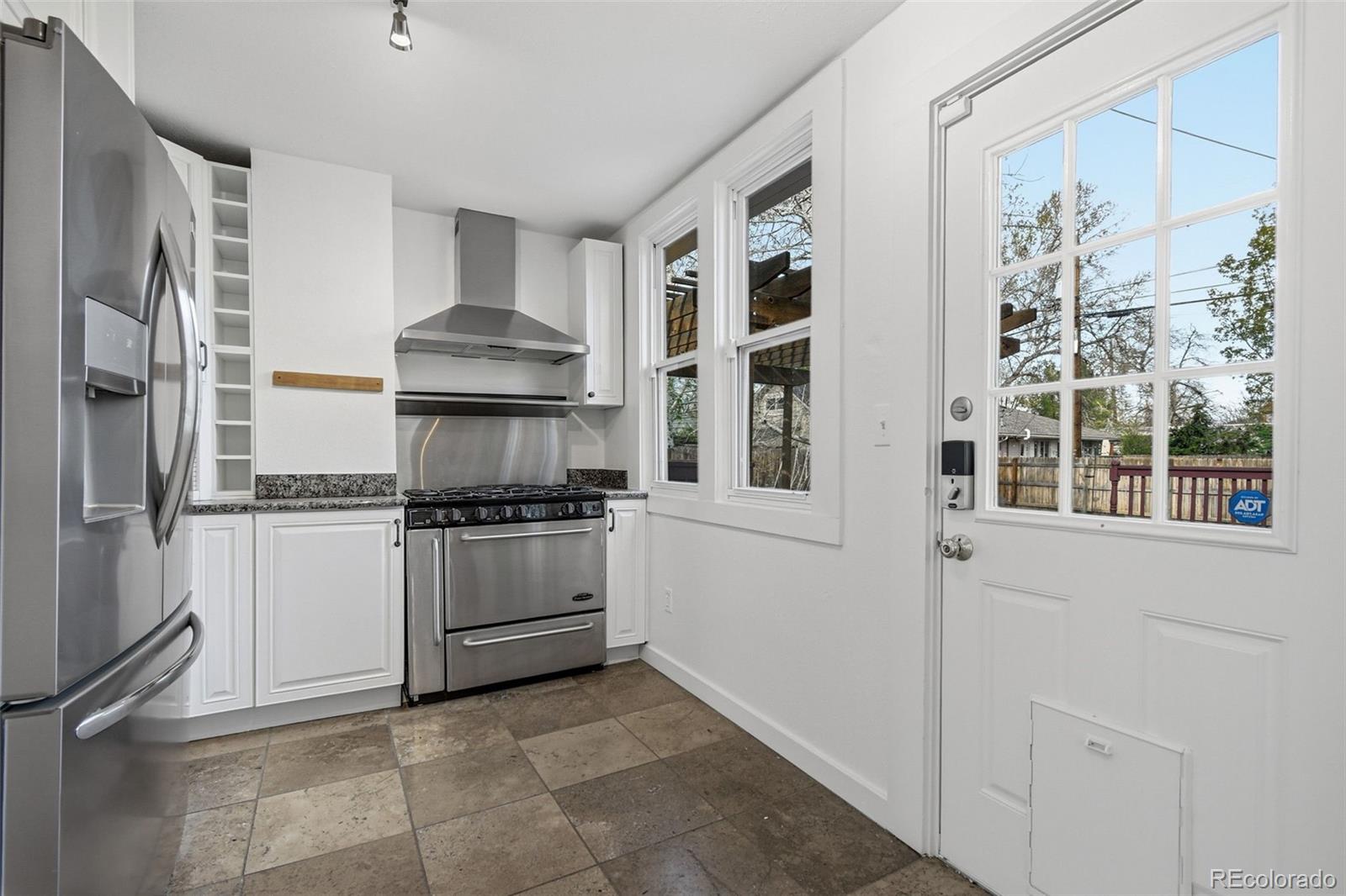 4182 Yates Street Denver, CO 80212 - Photo 21 of 48 a kitchen with a stove and a refrigerator