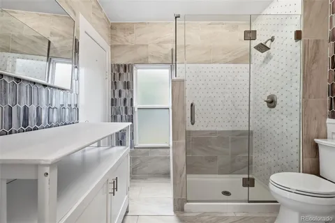 a bathroom with a shower and a toilet