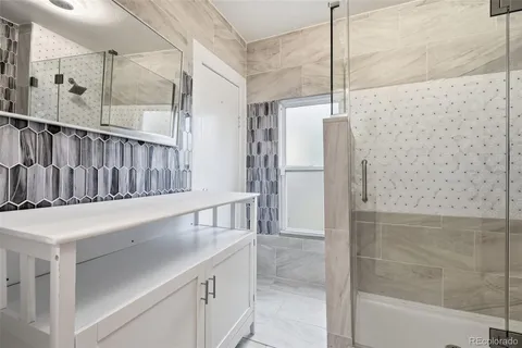 a view of bathroom with tub and shower