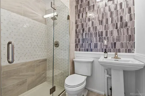a bathroom with a sink toilet and shower