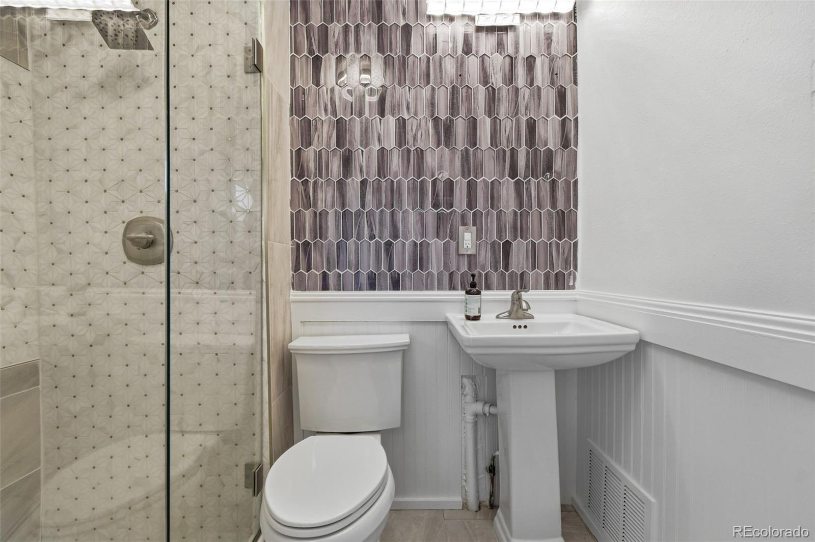 4182 Yates Street Denver, CO 80212 - Photo 31 of 48 a bathroom with a sink a toilet and shower