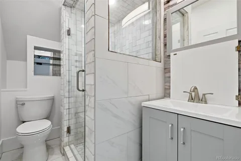 a bathroom with a toilet sink and shower