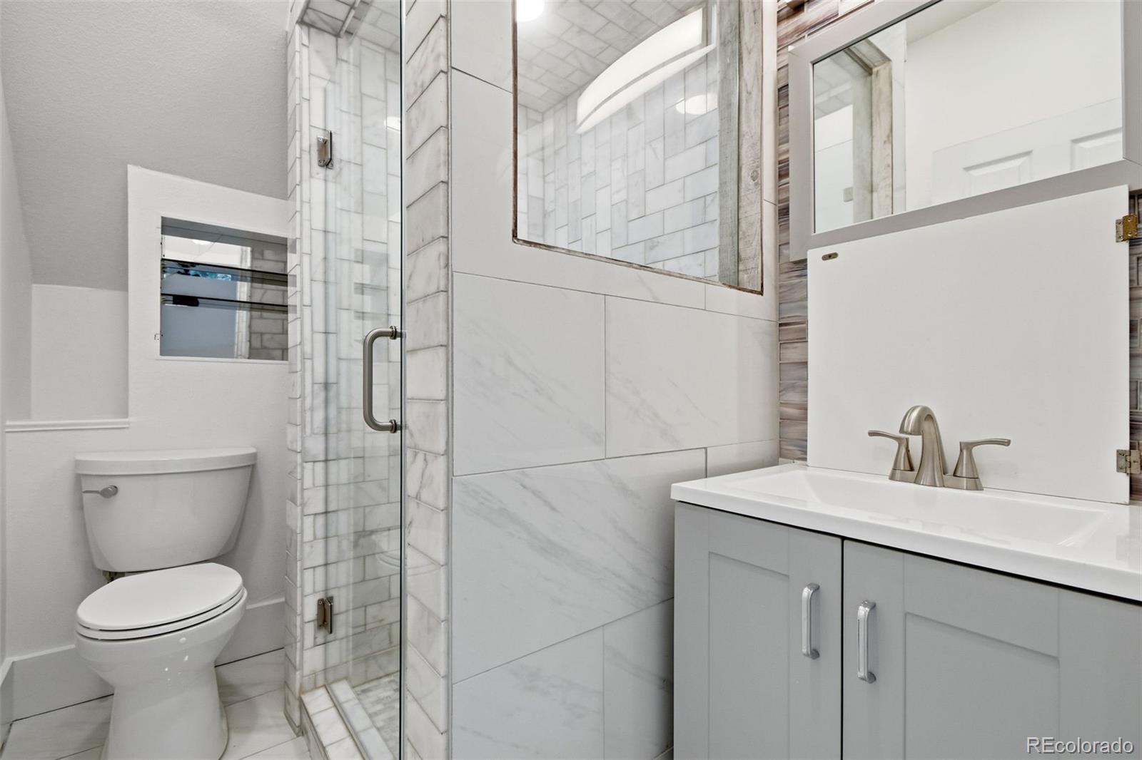 4182 Yates Street Denver, CO 80212 - Photo 35 of 48 a bathroom with a toilet sink and shower